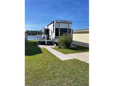 LAKEFRONT LIVING! RETIRE WITH CONFIDENCE!! Welcome to Kove on Cypress Point RV Golf Club in Florida - for sale on GolfHomes.com, golf home, golf lot
