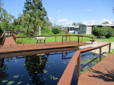 This 2 bedroom 2 bath home is situated on an oversized lot just on Bay Tree Golf Course in Florida - for sale on GolfHomes.com, golf home, golf lot