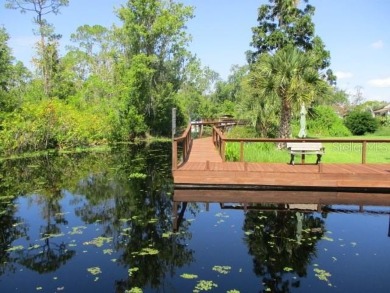 This 2 bedroom 2 bath home is situated on an oversized lot just on Bay Tree Golf Course in Florida - for sale on GolfHomes.com, golf home, golf lot