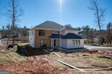 This gorgeous new construction is directly on Osprey Pointe Pond on Harbor Club Golf and Country Club in Georgia - for sale on GolfHomes.com, golf home, golf lot