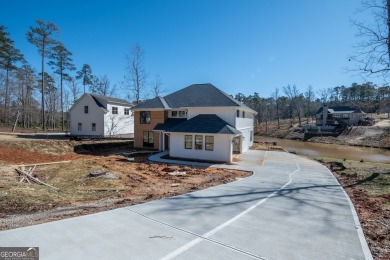 This gorgeous new construction is directly on Osprey Pointe Pond on Harbor Club Golf and Country Club in Georgia - for sale on GolfHomes.com, golf home, golf lot