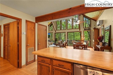 Well-loved mountain home tucked in the woods along the golf on Land Harbor Golf Course in North Carolina - for sale on GolfHomes.com, golf home, golf lot