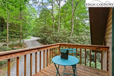 Well-loved mountain home tucked in the woods along the golf on Land Harbor Golf Course in North Carolina - for sale on GolfHomes.com, golf home, golf lot