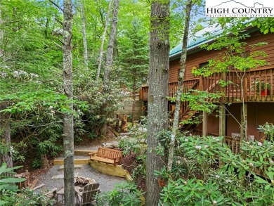 Well-loved mountain home tucked in the woods along the golf on Land Harbor Golf Course in North Carolina - for sale on GolfHomes.com, golf home, golf lot