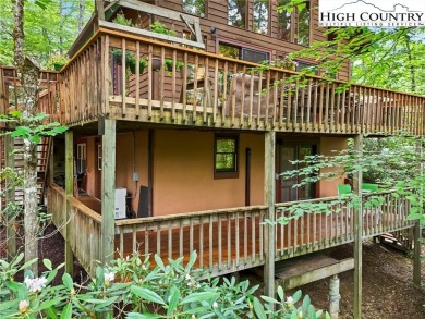 Well-loved mountain home tucked in the woods along the golf on Land Harbor Golf Course in North Carolina - for sale on GolfHomes.com, golf home, golf lot