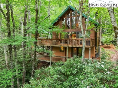 Well-loved mountain home tucked in the woods along the golf on Land Harbor Golf Course in North Carolina - for sale on GolfHomes.com, golf home, golf lot