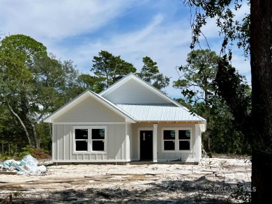 Brand-new construction situated on a peaceful half-acre wooded on Peninsula Golf and Racquet Club in Alabama - for sale on GolfHomes.com, golf home, golf lot