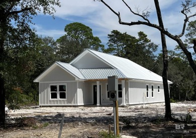 Brand-new construction situated on a peaceful half-acre wooded on Peninsula Golf and Racquet Club in Alabama - for sale on GolfHomes.com, golf home, golf lot