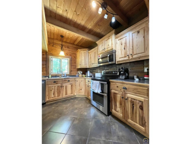 Opportunity awaits! Gorgeous log home living on a quiet street on Lake Perry Country Club in Kansas - for sale on GolfHomes.com, golf home, golf lot