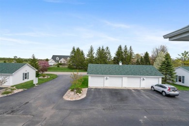 Welcome to this upper-level 2-bedroom, 2-bath condo in the on Charlevoix Golf and Country Club in Michigan - for sale on GolfHomes.com, golf home, golf lot