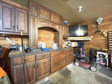 Opportunity awaits! Gorgeous log home living on a quiet street on Lake Perry Country Club in Kansas - for sale on GolfHomes.com, golf home, golf lot