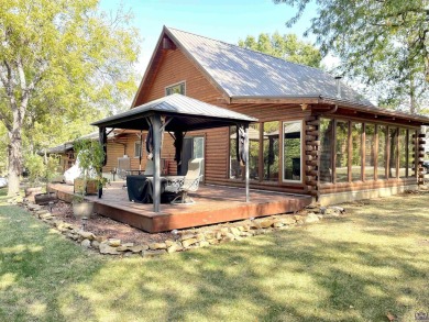 Opportunity awaits! Gorgeous log home living on a quiet street on Lake Perry Country Club in Kansas - for sale on GolfHomes.com, golf home, golf lot