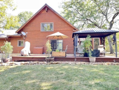 Opportunity awaits! Gorgeous log home living on a quiet street on Lake Perry Country Club in Kansas - for sale on GolfHomes.com, golf home, golf lot