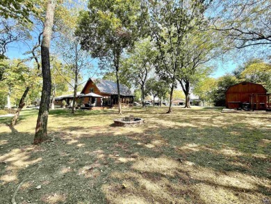 Opportunity awaits! Gorgeous log home living on a quiet street on Lake Perry Country Club in Kansas - for sale on GolfHomes.com, golf home, golf lot