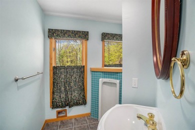 Perched at the crest of a wooded hill, this distinctive on Birchwood Farms Golf and Country Club in Michigan - for sale on GolfHomes.com, golf home, golf lot