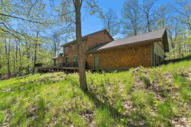 Perched at the crest of a wooded hill, this distinctive on Birchwood Farms Golf and Country Club in Michigan - for sale on GolfHomes.com, golf home, golf lot