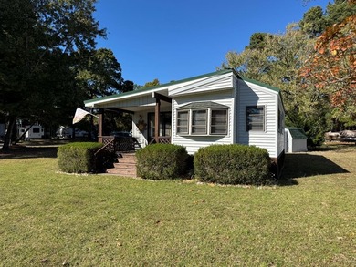 Oversized lot with park trailer, septic, room addition, deck on Captains Cove Golf and Yacht Club in Virginia - for sale on GolfHomes.com, golf home, golf lot