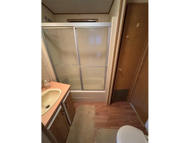 Oversized lot with park trailer, septic, room addition, deck on Captains Cove Golf and Yacht Club in Virginia - for sale on GolfHomes.com, golf home, golf lot