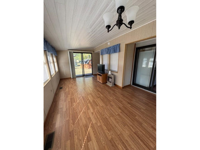 Oversized lot with park trailer, septic, room addition, deck on Captains Cove Golf and Yacht Club in Virginia - for sale on GolfHomes.com, golf home, golf lot