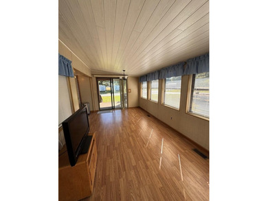 Oversized lot with park trailer, septic, room addition, deck on Captains Cove Golf and Yacht Club in Virginia - for sale on GolfHomes.com, golf home, golf lot