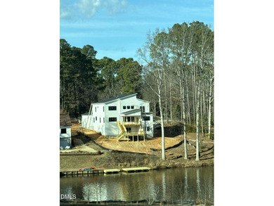 Discover lakeside luxury and convenience in this stunning on River Golf and Country Club at Lake Royale in North Carolina - for sale on GolfHomes.com, golf home, golf lot