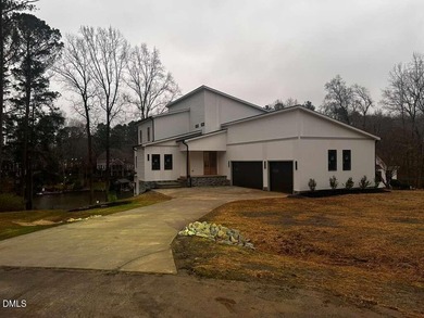 Discover lakeside luxury and convenience in this stunning on River Golf and Country Club at Lake Royale in North Carolina - for sale on GolfHomes.com, golf home, golf lot