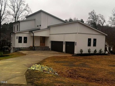 Discover lakeside luxury and convenience in this stunning on River Golf and Country Club at Lake Royale in North Carolina - for sale on GolfHomes.com, golf home, golf lot