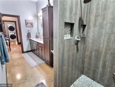 Tucked away in the woods on a spacious 1.8-acre lot, this modern on Whispering Pines Golf Club in Minnesota - for sale on GolfHomes.com, golf home, golf lot