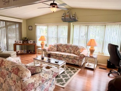 Discover this charming two-bedroom, two-bathroom home in the on Pine Lakes Country Club in Florida - for sale on GolfHomes.com, golf home, golf lot