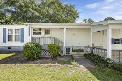 This home is nestled on a picturesque homesite on a quaint on Topsail Green Golf Club in North Carolina - for sale on GolfHomes.com, golf home, golf lot