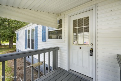 This home is nestled on a picturesque homesite on a quaint on Topsail Green Golf Club in North Carolina - for sale on GolfHomes.com, golf home, golf lot