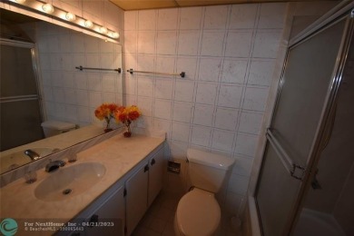 Discover convenience, and scenic beauty in this lovely 2-bedroom on Inverrary Country Club in Florida - for sale on GolfHomes.com, golf home, golf lot
