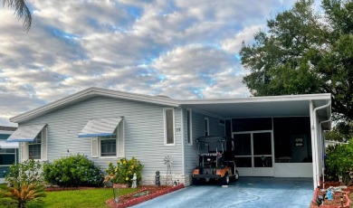 This approx 1200 sf 1990 2 bedroom 2 bath home is located in the on Lake Henry Golf Club in Florida - for sale on GolfHomes.com, golf home, golf lot