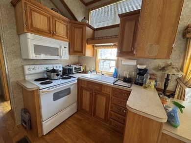 You have to check out this beautiful park model on a corner lot on Captains Cove Golf and Yacht Club in Virginia - for sale on GolfHomes.com, golf home, golf lot