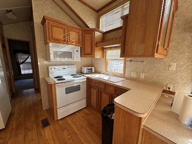 You have to check out this beautiful park model on a corner lot on Captains Cove Golf and Yacht Club in Virginia - for sale on GolfHomes.com, golf home, golf lot