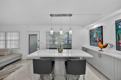 First-floor, fully renovated lakefront residence designed for on Wynmoor Golf Course in Florida - for sale on GolfHomes.com, golf home, golf lot