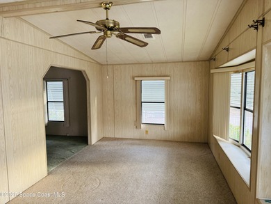 Dont miss this 2-bedroom, 2-bath mobile home featuring a on Barefoot Bay Golf Course in Florida - for sale on GolfHomes.com, golf home, golf lot
