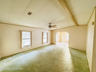 Dont miss this 2-bedroom, 2-bath mobile home featuring a on Barefoot Bay Golf Course in Florida - for sale on GolfHomes.com, golf home, golf lot