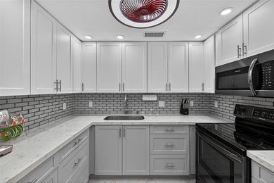 First-floor, fully renovated lakefront residence designed for on Wynmoor Golf Course in Florida - for sale on GolfHomes.com, golf home, golf lot