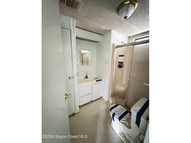 Dont miss this 2-bedroom, 2-bath mobile home featuring a on Barefoot Bay Golf Course in Florida - for sale on GolfHomes.com, golf home, golf lot