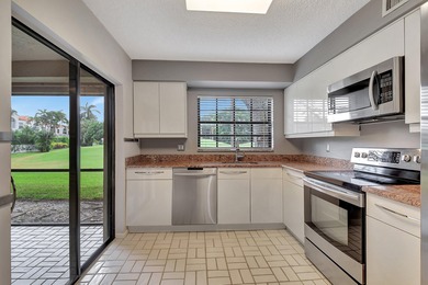 Perfectly located first floor condo residence with long views of on Bocaire Country Club in Florida - for sale on GolfHomes.com, golf home, golf lot