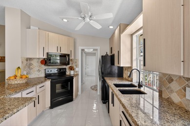 Extremely well-maintained villa with 2 car garage overlooking on The Golf Club of Jupiter in Florida - for sale on GolfHomes.com, golf home, golf lot