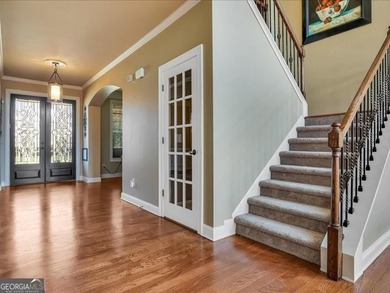 Experience luxury living in this expansive 5,300+ sq ft, 6BR/5BA on Mirror Lake Golf Club in Georgia - for sale on GolfHomes.com, golf home, golf lot