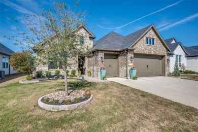 From the moment you pull up outside, the curb appeal welcomes on Wildhorse Golf Club of Robson Ranch in Texas - for sale on GolfHomes.com, golf home, golf lot