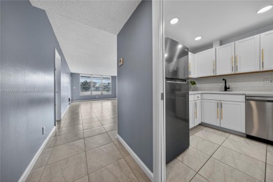Thoughtfully updated with high-end finishes throughout, this on Palm-Aire Country Club and Resort - Palms in Florida - for sale on GolfHomes.com, golf home, golf lot