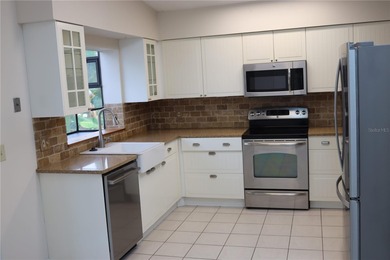 Welcome to this charming 2-bedroom, 2-bath home tucked inside on Tuscawilla Country Club in Florida - for sale on GolfHomes.com, golf home, golf lot