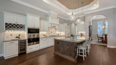 Positioned on a premier homesite with water on two sides and on Ritz-Carlton Members Golf Club in Florida - for sale on GolfHomes.com, golf home, golf lot