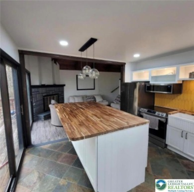 Don't let the outside fool you, this home feels more spacious on Pocono Farms Country Club in Pennsylvania - for sale on GolfHomes.com, golf home, golf lot