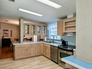 This spacious 3 bdrm,2 bath PALM HARBOR is completely furnished on Southport Springs Golf Club in Florida - for sale on GolfHomes.com, golf home, golf lot