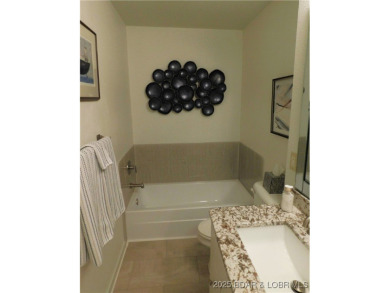 This ground-floor, 1-story, end unit enjoys easy access from the on Seasons Ridge At Four Seasons in Missouri - for sale on GolfHomes.com, golf home, golf lot